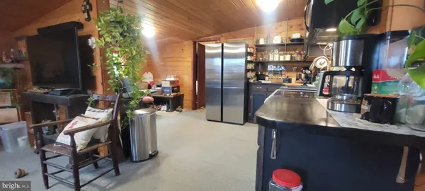 a kitchen with stainless steel appliances granite countertop a refrigerator a stove and a sink