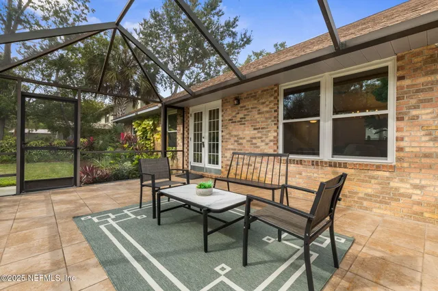 a view of a patio with a table and chairs