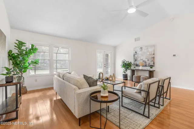 a living room with furniture and a potted plant