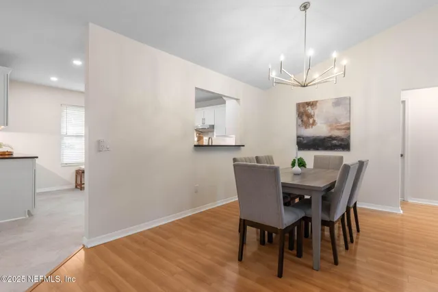 a view of a dining room with furniture wooden floor and chandelier