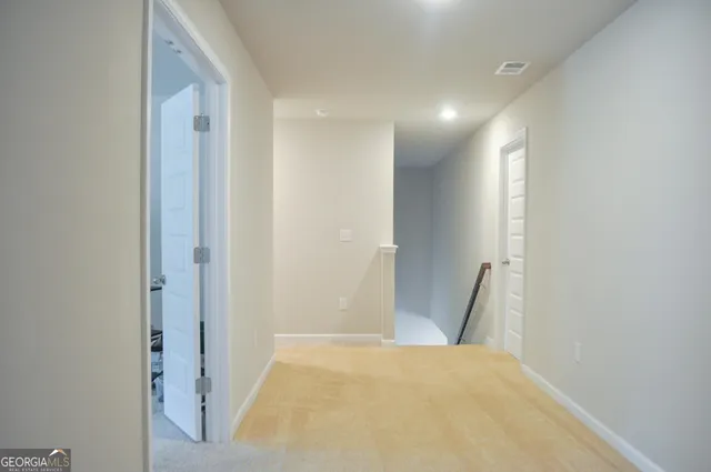 a view of a hallway to rooms