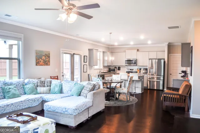a living room with furniture and a large window