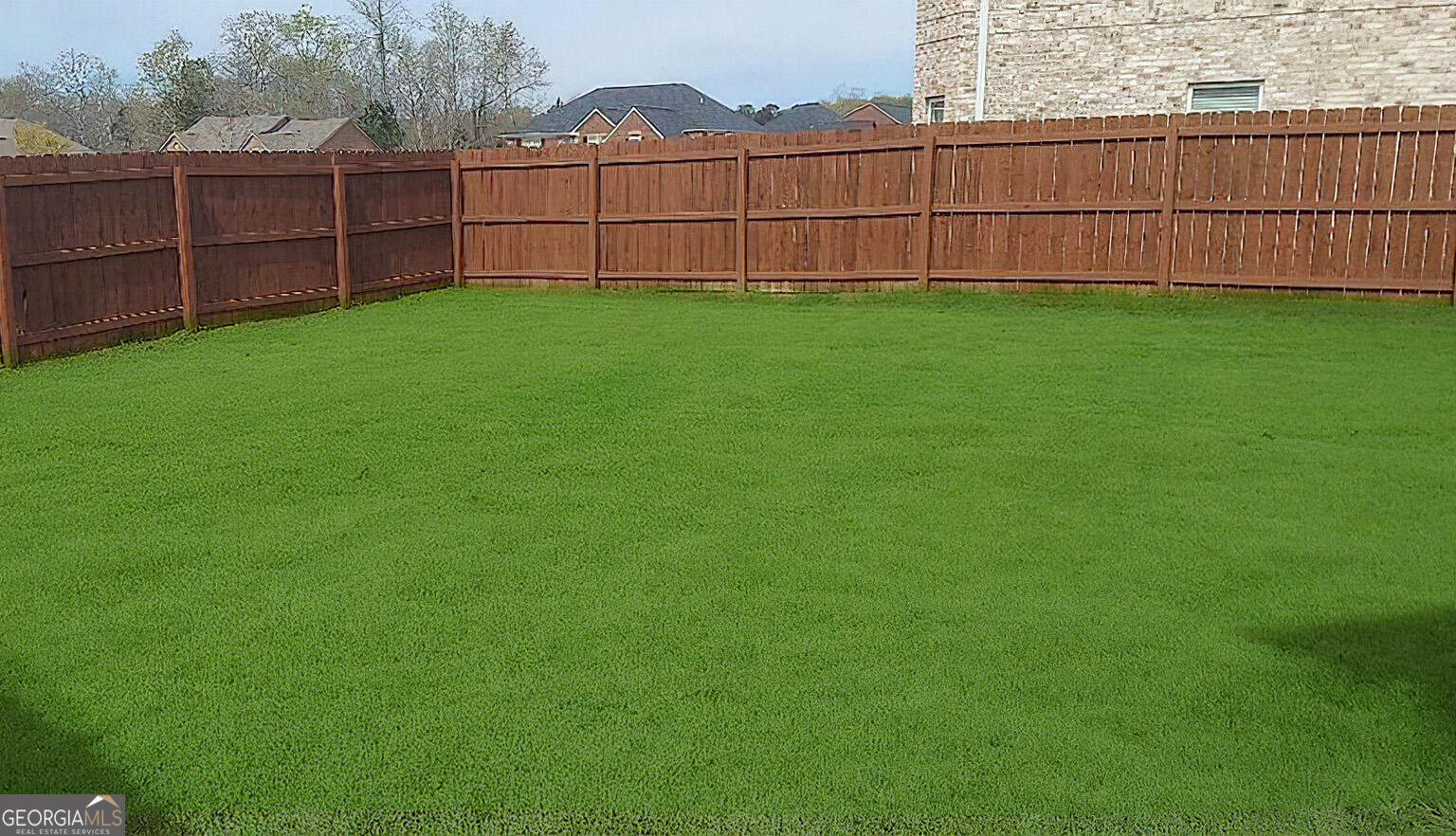 1493 Harlequin Way Stockbridge, GA 30281 - Photo 5 of 15 a view of a backyard with wooden fence