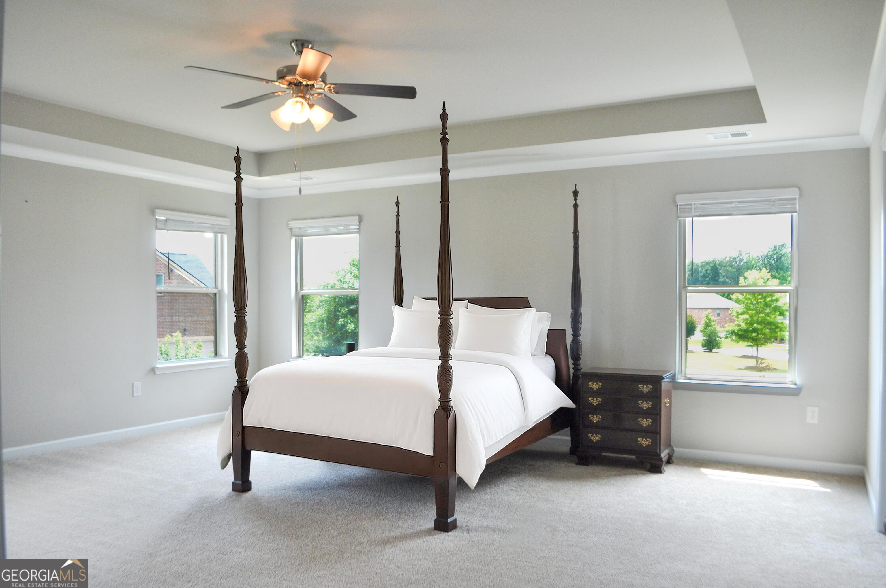 1493 Harlequin Way Stockbridge, GA 30281 - Photo 8 of 15 a bedroom with a bed chandelier and a window