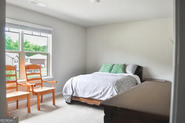 a bedroom with a bed and a couch