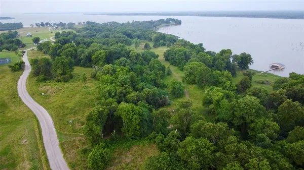 a view of a lake in middle of the green field