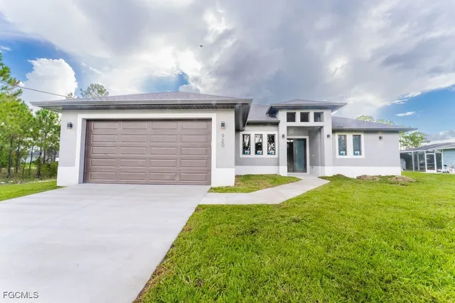 a front view of a house with a yard and garage