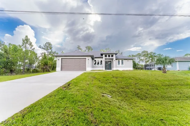a front view of a house with a yard