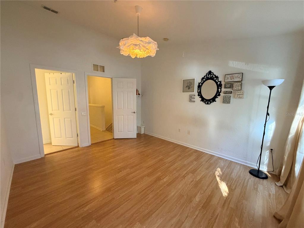 2837 Villafuerte Point, Unit 105 Orlando, FL 32835 - Photo 13 of 23 a view of a room with wooden floor and window