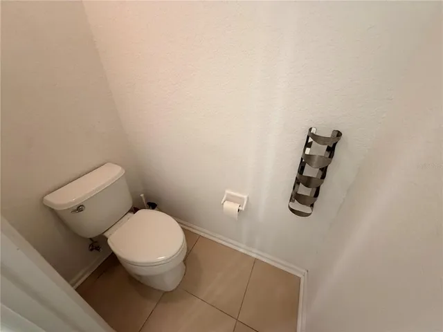 a white toilet sitting next to a bathroom