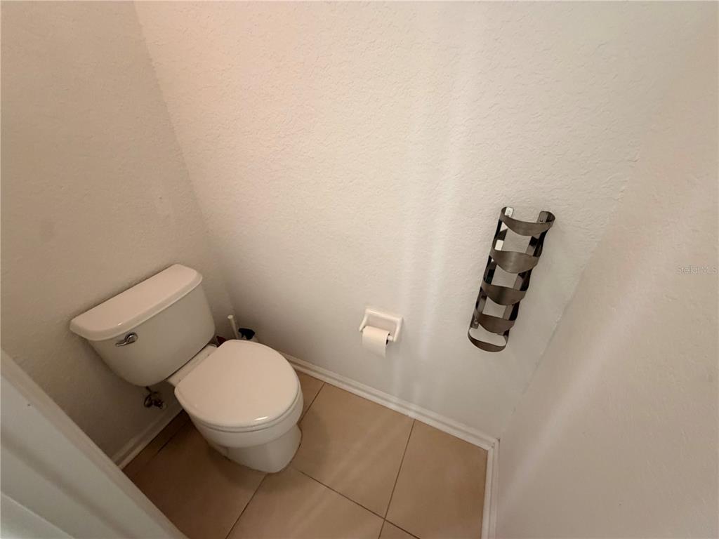 2837 Villafuerte Point, Unit 105 Orlando, FL 32835 - Photo 15 of 23 a white toilet sitting next to a bathroom