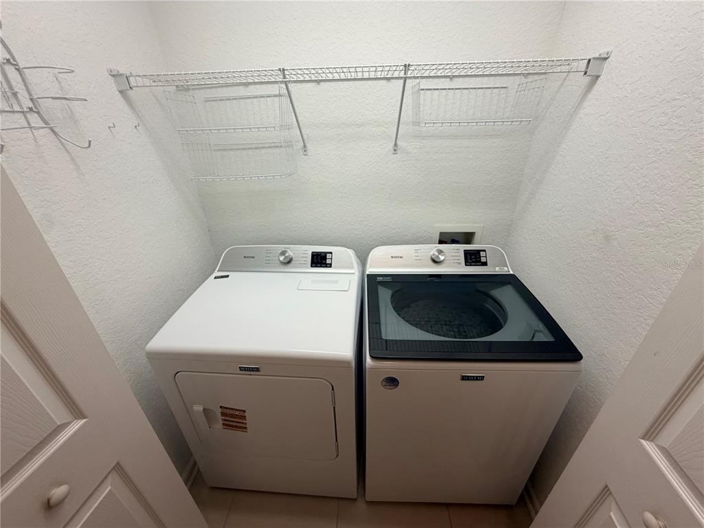 2837 Villafuerte Point, Unit 105 Orlando, FL 32835 - Photo 17 of 23 a utility room with dryer and washer