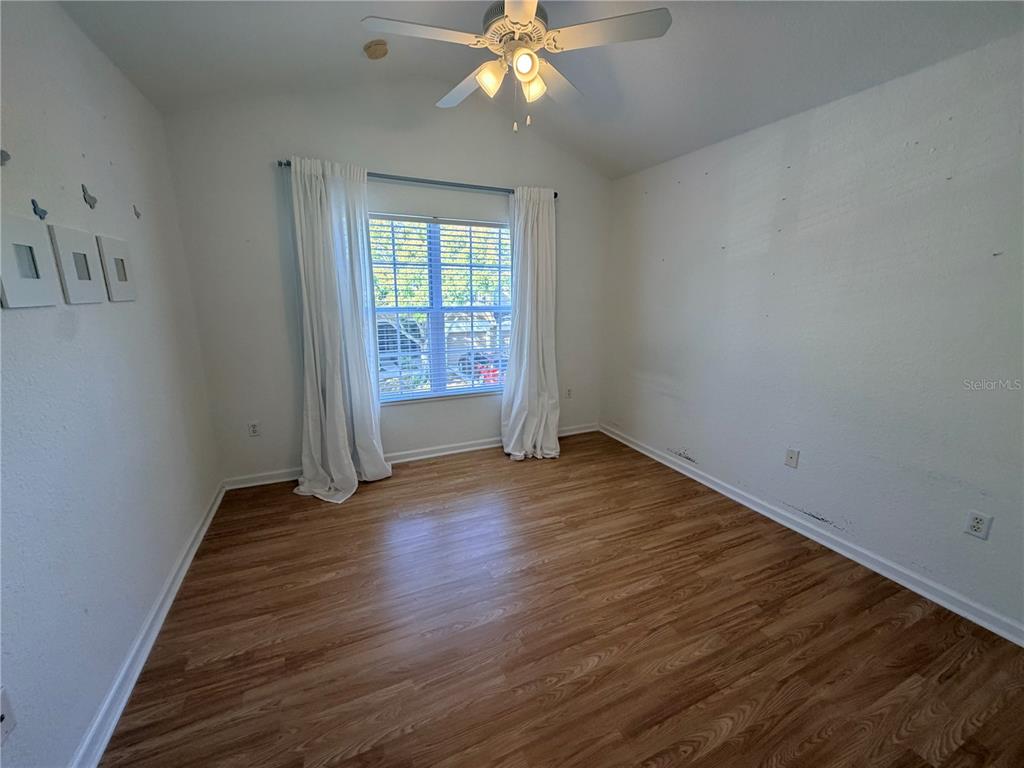 2837 Villafuerte Point, Unit 105 Orlando, FL 32835 - Photo 20 of 23 wooden floor in an empty room with a window