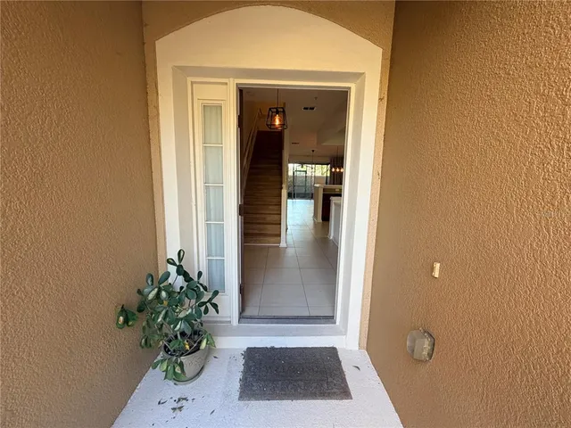 a view of a hallway with potted plants