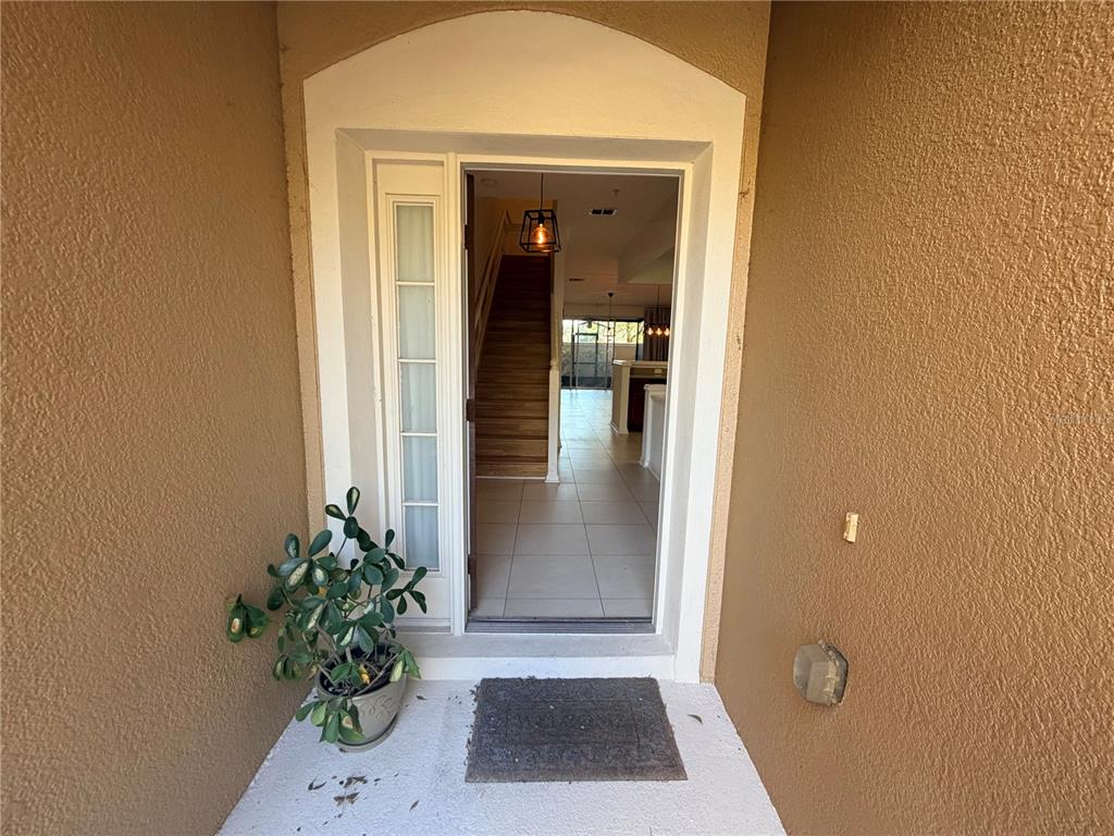 2837 Villafuerte Point, Unit 105 Orlando, FL 32835 - Photo 3 of 23 a view of a hallway with potted plants