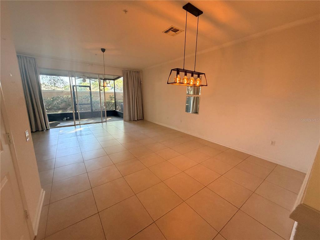 2837 Villafuerte Point, Unit 105 Orlando, FL 32835 - Photo 8 of 23 a view of a room with window and chandelier