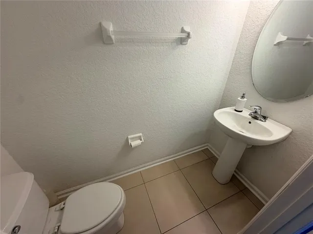 a bathroom with a sink mirror and toilet