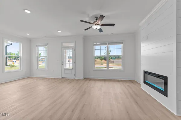 a view of a livingroom with kitchen appliances and a window