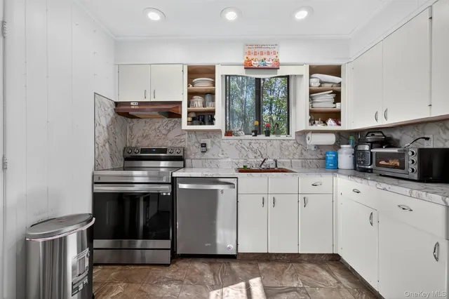 a kitchen with stainless steel appliances granite countertop a refrigerator and a stove