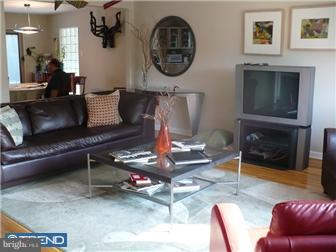 1437 Shoemaker Road Abington, PA 19001 - Photo 3 of 12 a living room with furniture a flat screen tv and a fireplace