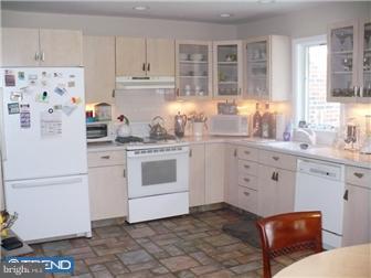 1437 Shoemaker Road Abington, PA 19001 - Photo 6 of 12 a kitchen with white cabinets and white appliances