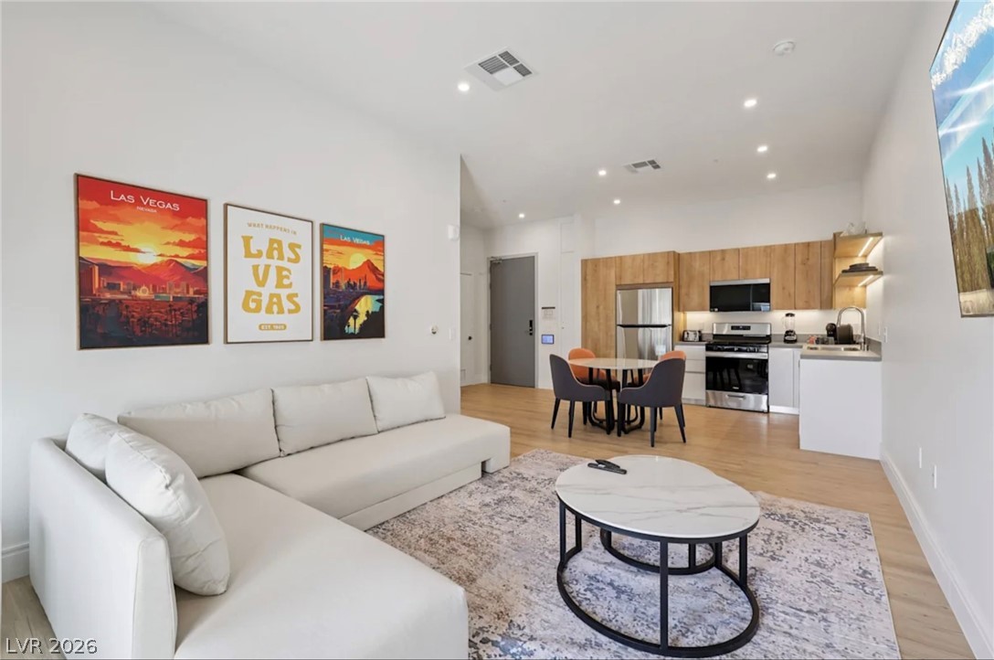5050 West Russell Road, Unit 121 Las Vegas, NV 89118 - Photo 1 of 6 Clean lines and smooth hardwood flooring define this contemporary open concept living space.