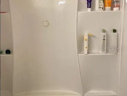 a view of a dining room with furniture and a chandelier