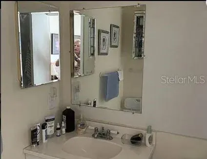 a bathroom with a sink and a mirror