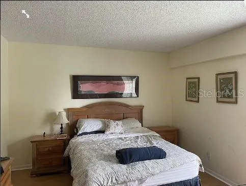 a bed sitting in a bedroom and painting on the wall
