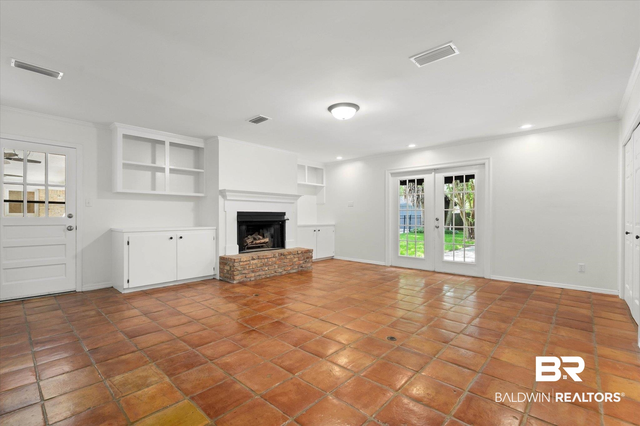 555 East Cumberland Road Mobile, AL 36608 - Photo 5 of 21 Unfurnished living room featuring tile patterned flooring, a fireplace, and visible vents
