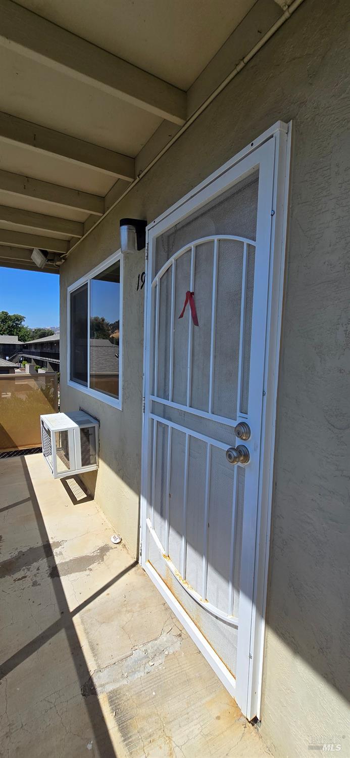 1567 Alamo Drive, Unit 19 Vacaville, CA 95687 - Photo 1 of 7 a bedroom with furniture and a flat screen tv