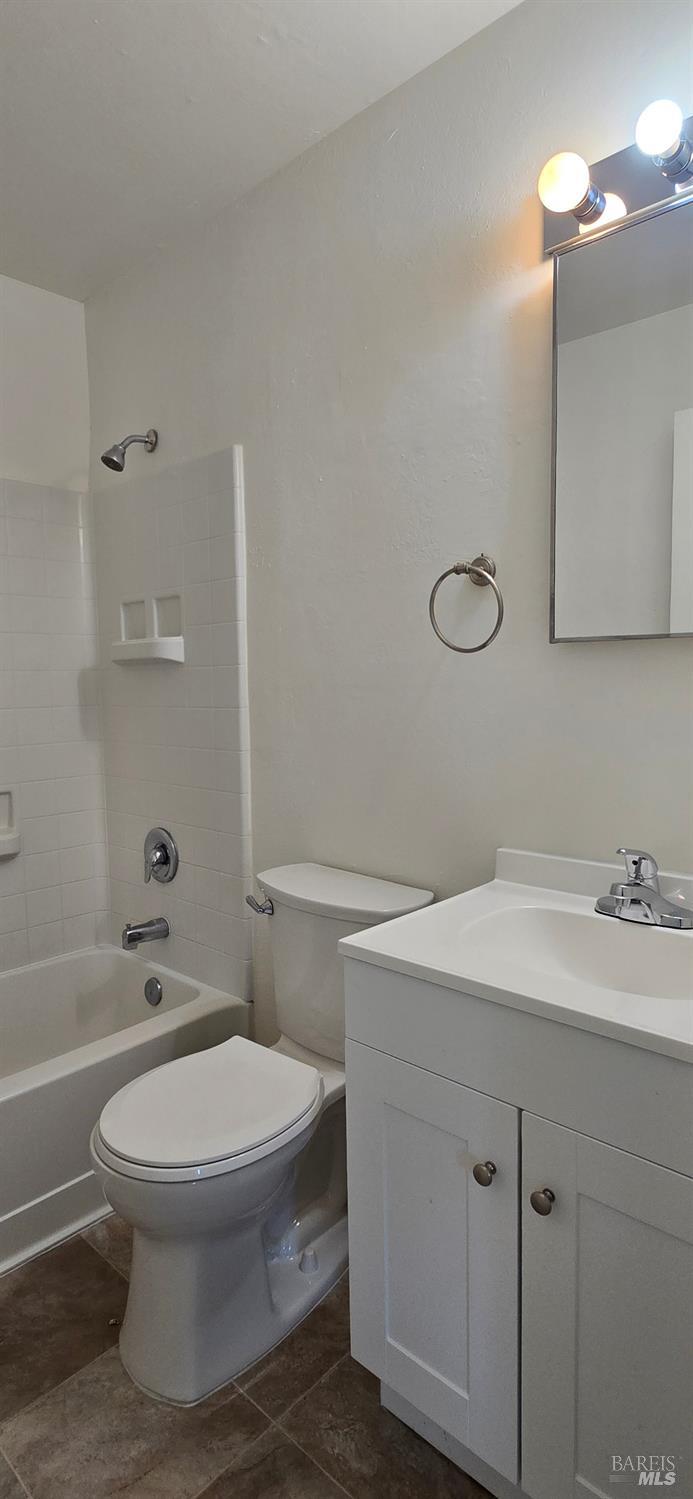 1567 Alamo Drive, Unit 19 Vacaville, CA 95687 - Photo 5 of 7 a bathroom with a sink a toilet and a mirror