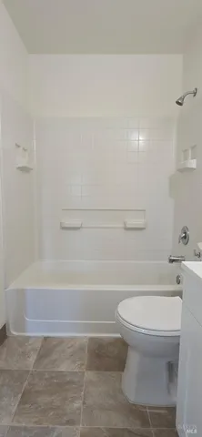 a bathroom with a toilet and a bathtub