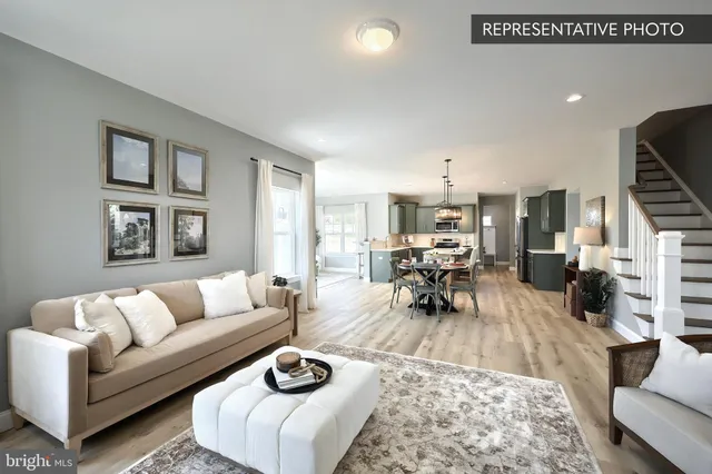 a living room with furniture a rug and a chandelier
