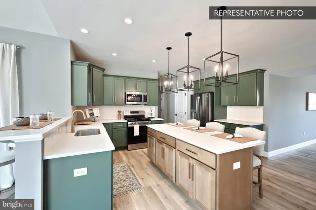 a kitchen that has a sink a table and chairs in it