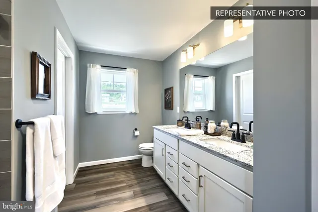 a bathroom with a double vanity sink and a mirror