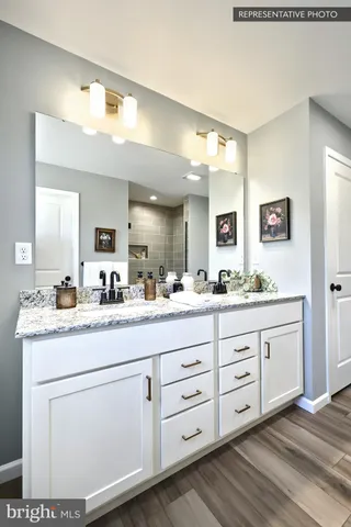 a bathroom with a double vanity sink and a mirror