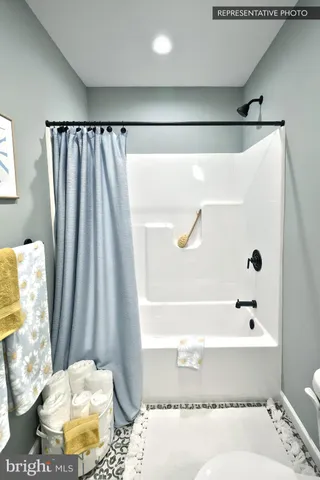 a bathroom with a bathtub and shower