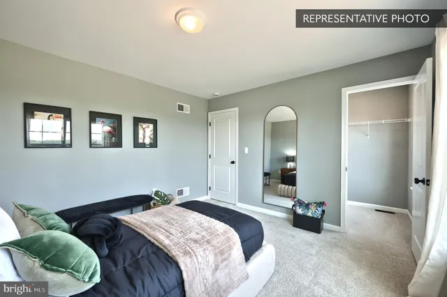 a spacious bedroom with a bed and closet