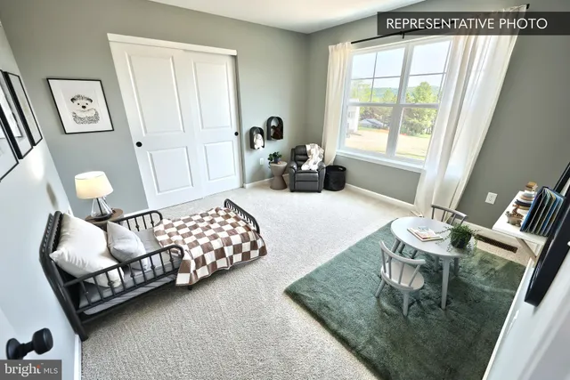 a bedroom with furniture and a large window
