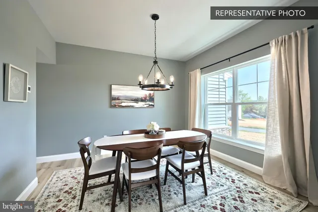a dining room with a table and chairs