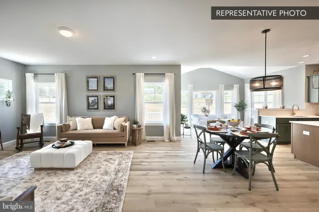 a living room with furniture wooden floor and a window