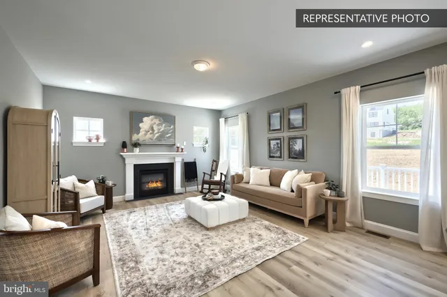 a living room with furniture a fireplace and a window