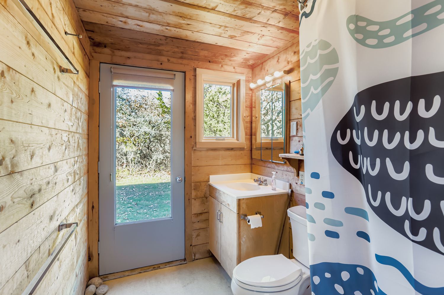 7 Black Point Road Chilmark, MA 02535 - Photo 20 of 47 a bathroom with a sink a toilet and a shower curtain