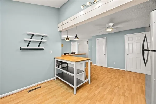 a kitchen with stainless steel appliances kitchen island a stove and a refrigerator