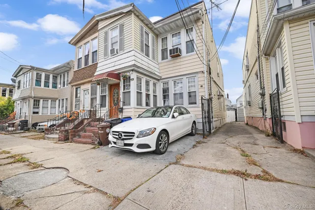 a car parked in front of a white building