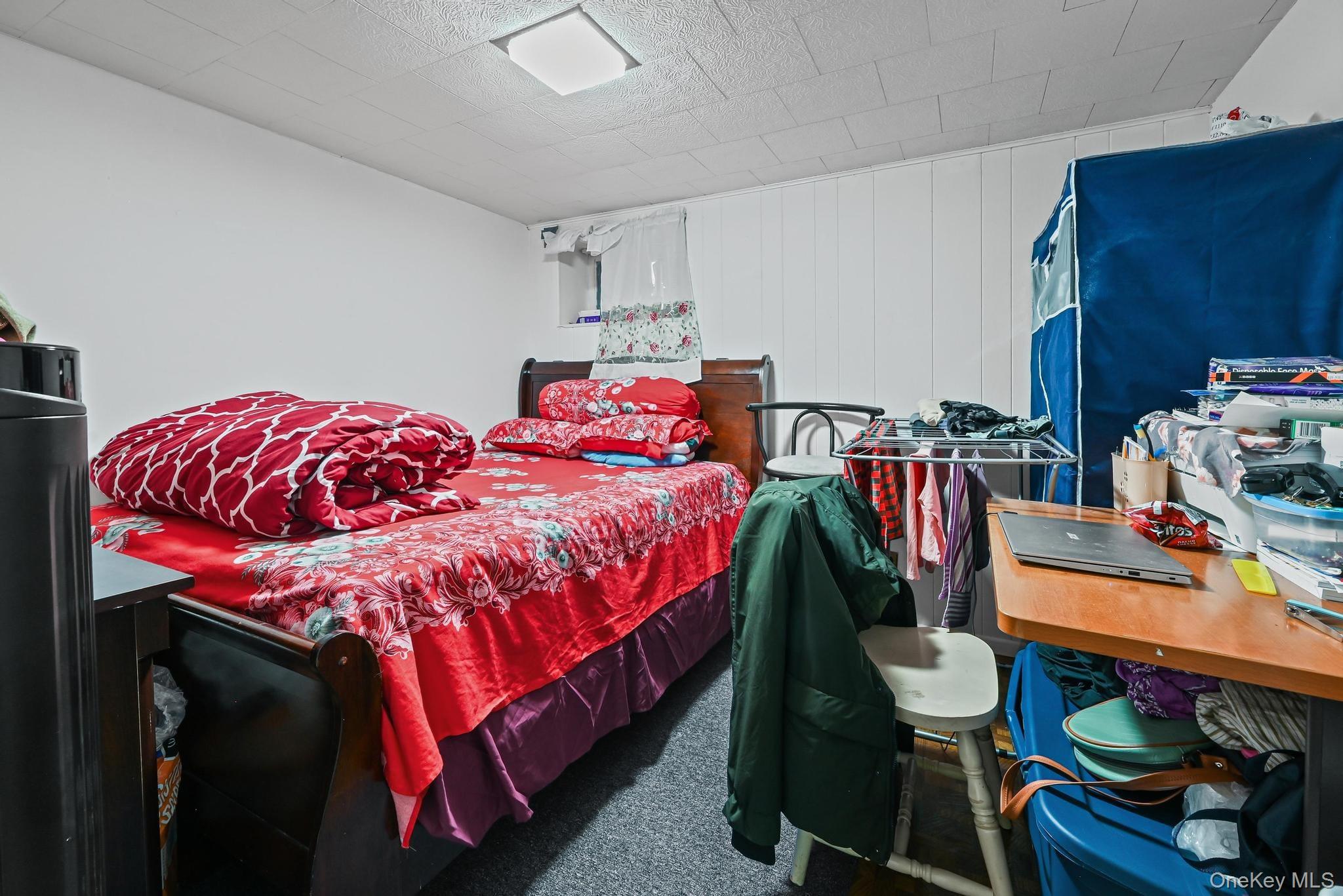 90-16 76th Street Queens, NY 11421 - Photo 11 of 28 a bedroom with a bed and a dresser in it