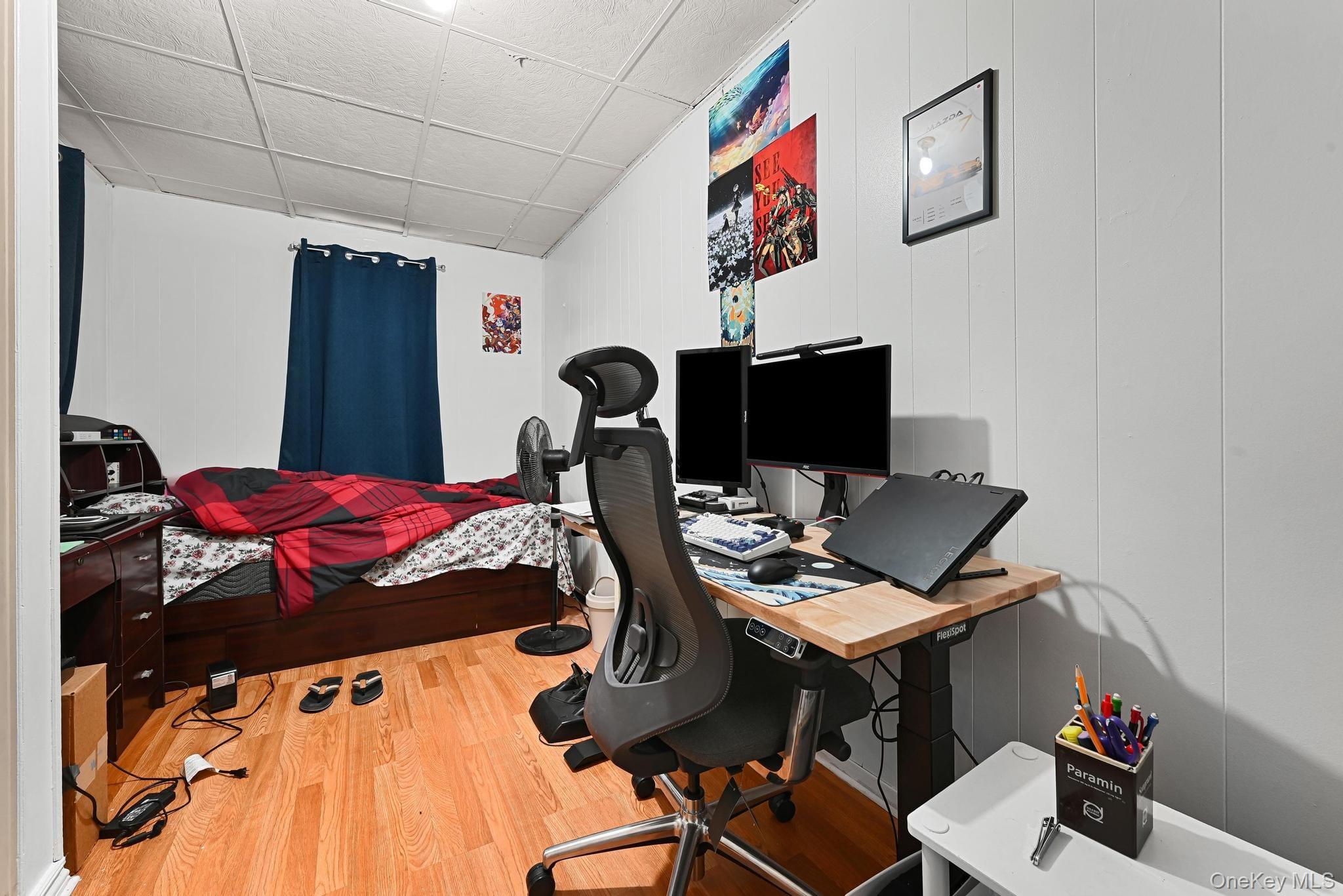 90-16 76th Street Queens, NY 11421 - Photo 13 of 28 a bed room with a bed and a desk