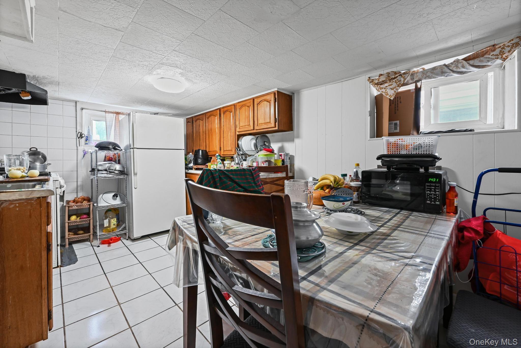 90-16 76th Street Queens, NY 11421 - Photo 17 of 28 a view of a kitchen and dining room