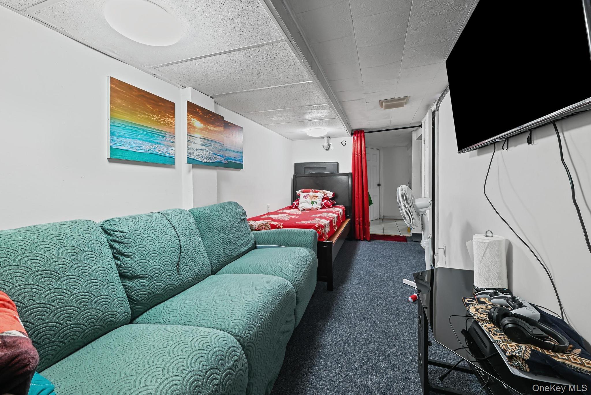 90-16 76th Street Queens, NY 11421 - Photo 18 of 28 a bedroom with furniture and a flat screen tv